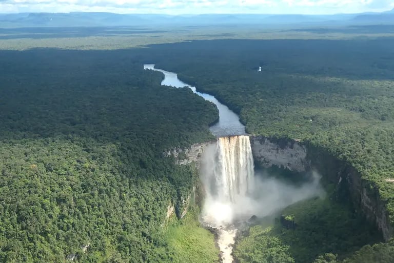 Aerial view of Kaieteur Falls in Guyana surrounded by lush tropical rainforest and the Potaro River.