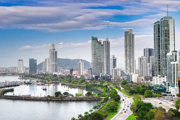 Panoramic skyline of Panama City featuring modern skyscrapers, the coastal beltway, and scenic bay views.