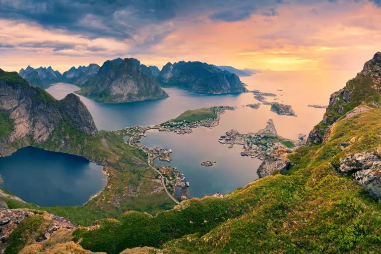 Panoramic sunset view of Reine village and fjords in Lofoten Islands, Norway from Reinebringen mountain.