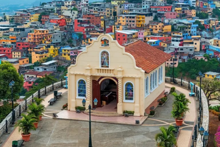 A cream-colored hilltop chapel overlooking the colorful houses of Guayaquil, Ecuador, at Santa Ana Hill.