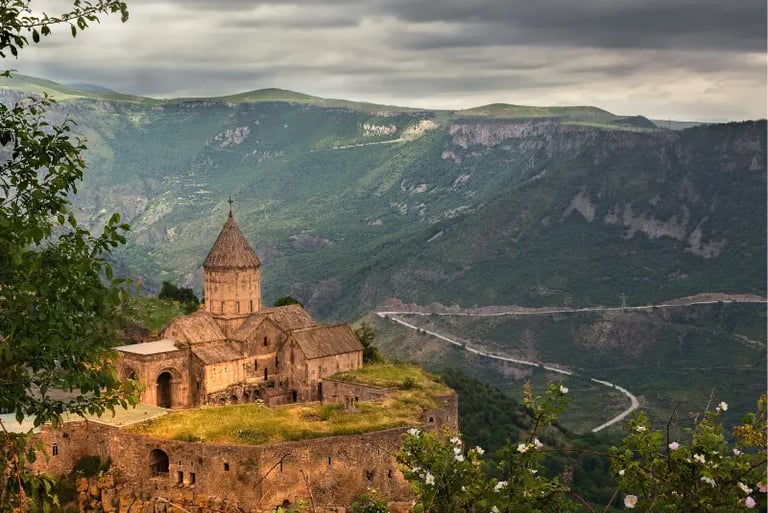 The historic Tatev Monastery perched on a basalt plateau overlooking the Vorotan River canyon in Armenia.