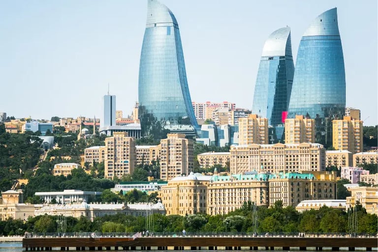 Panoramic view of the Flame Towers skyscrapers overlooking the Baku city skyline and Caspian Sea in Azerbaijan.