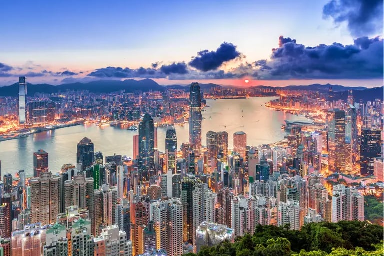 Panoramic sunset view of Hong Kong skyline and Victoria Harbour from Victoria Peak.