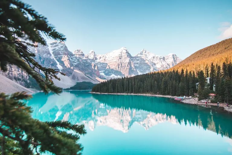 Scenic landscape of Moraine Lake in Banff National Park with turquoise water reflecting snow-capped Rocky Mountains.