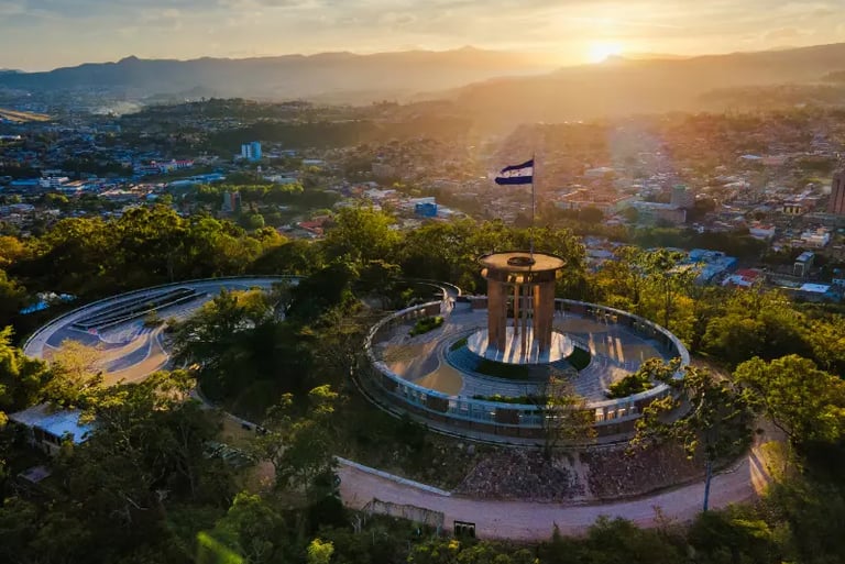 Aerial view of Cristo del Picacho park in Tegucigalpa, Honduras, at sunset with the national flag.