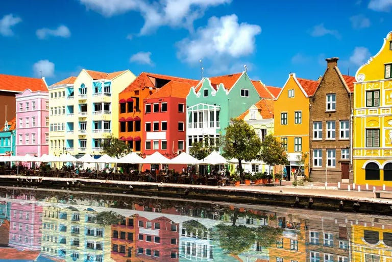 Colorful colonial architecture in Willemstad, Curacao, reflecting in the water of St. Anna Bay.