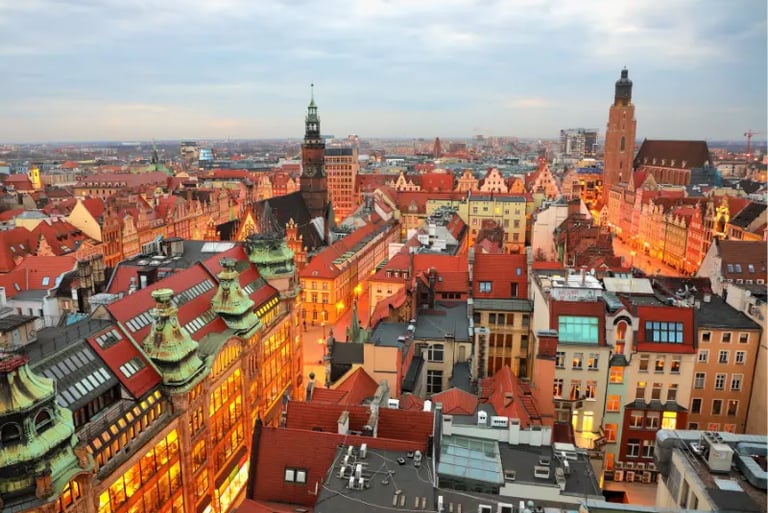Panoramic aerial view of Wroclaw Old Town at dusk featuring historic red roof architecture in Poland.