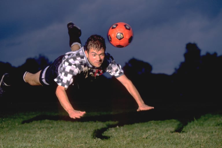 a man is playing soccer in the grass