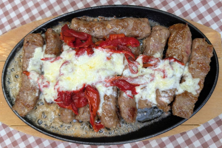 a sizzling pan of Čačak čevapi, sausage in Belgrade Serbia