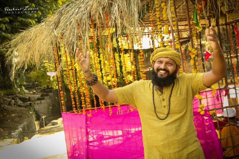 a man in a yellow turban and a pink scarf