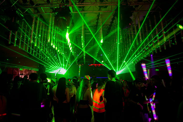 Pista de baile de fiesta de 15 con lasers verdes y jóvenes bailando