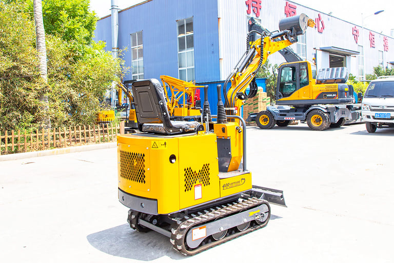 a yellow excavator is parked in front of a building