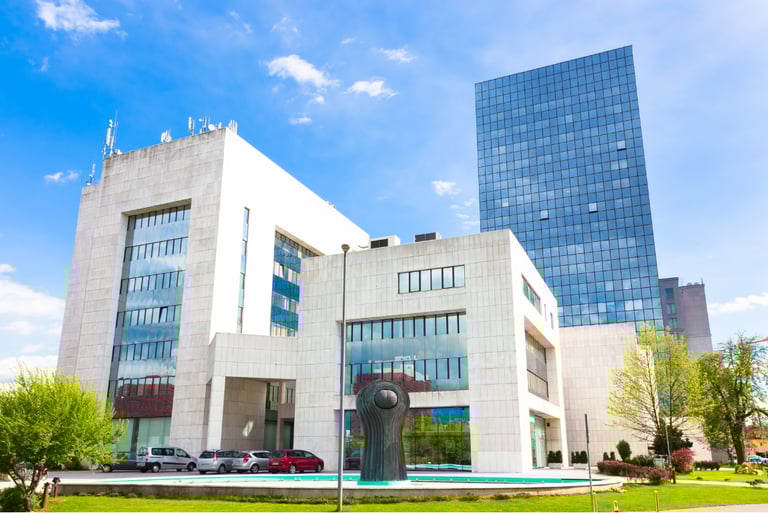 Modern office building with campus layout, symbolizing integrated surveillance and entry management