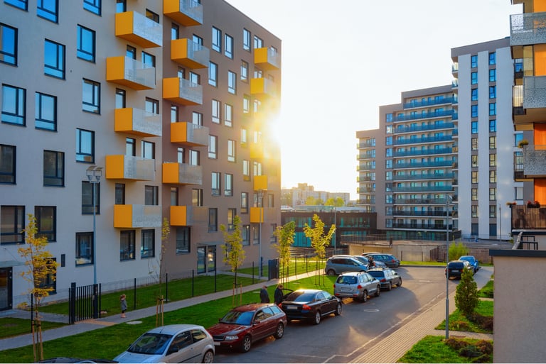 Modern apartment buildings with parking area, representing digital surveillance and access control integration