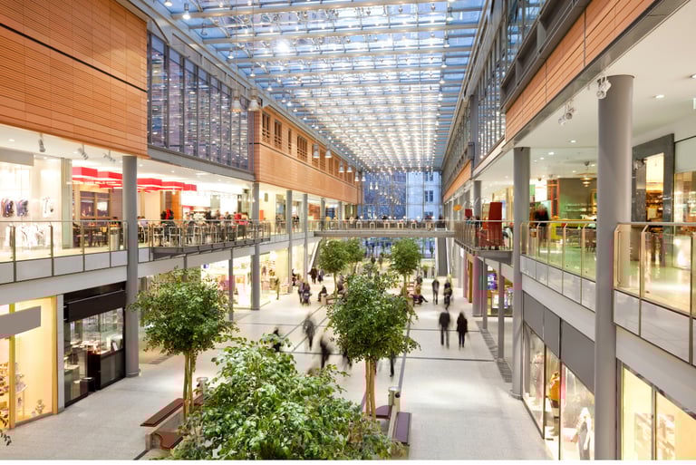 Shopping mall with bright indoor space and shops, illustrating high-traffic monitoring and surveillance