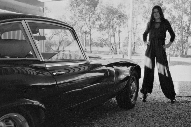 Lauren Hart strikes a pose with Peter Pickering's Jaguar E-Type V12