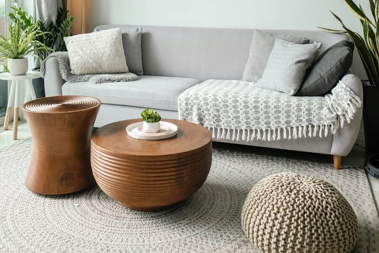 Scandinavian minimalism living room with circular knitted ottoman pouf and round wood coffee tables.