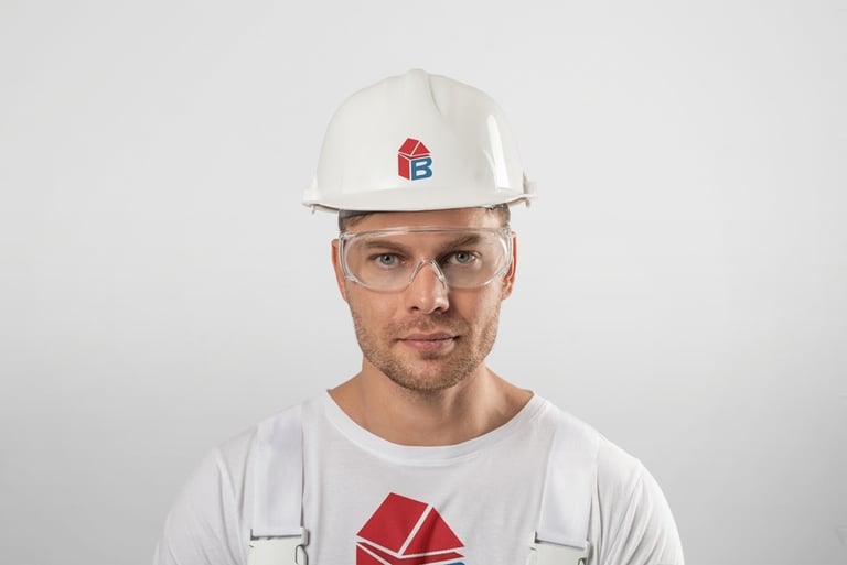 a man wearing a white hard hat and safety glasses