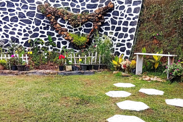 Pond and flower garden with bench at Nobel Bungalow Nuwara Eliya – peaceful outdoor space