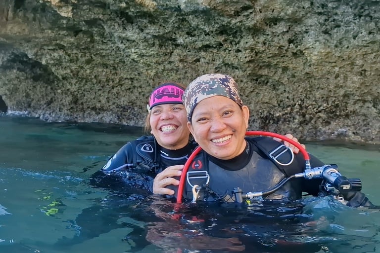 Scuba diver sisters having fun