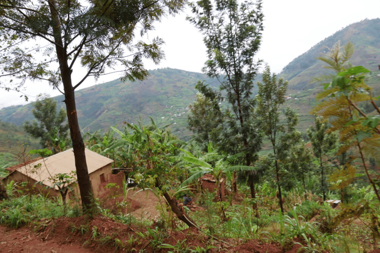 a house with a mountain view of a house in the background Rural Rwanda