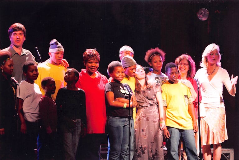 Angie Crouch, Love Hallie team, and Agape Orphans on stage at concert in Los Angeles