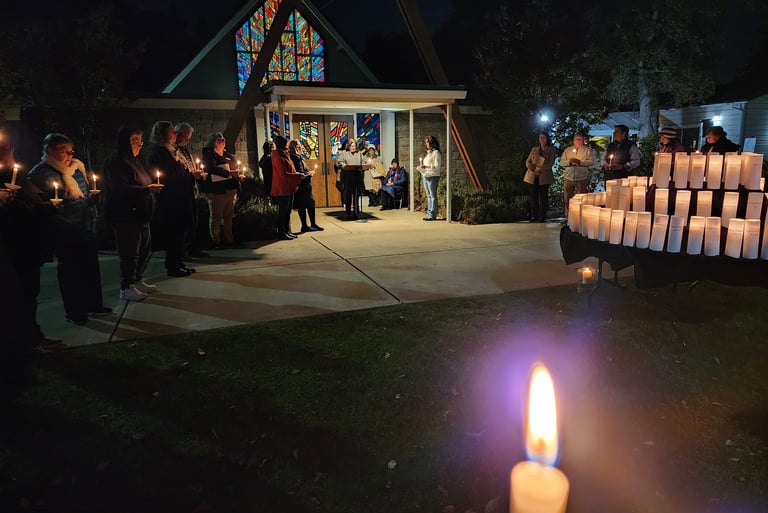 A prayer vigil for the unhoused who died. There is a candle for each death.