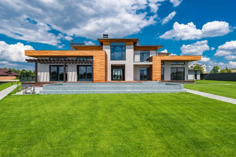 a large house with a lawn and a bench