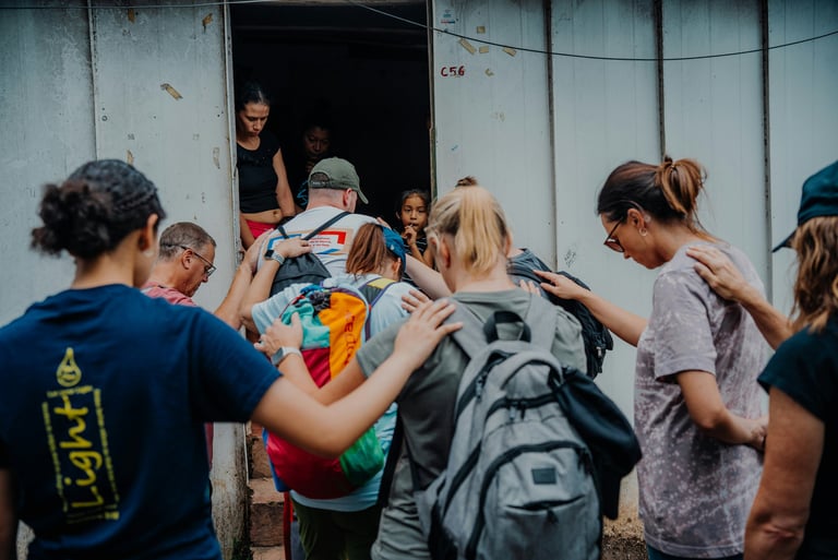 a group of people praying with hands on one another
