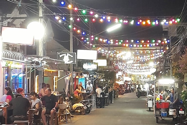 Customers sat outside bars on Soi 80, Hua Hin in Thailand