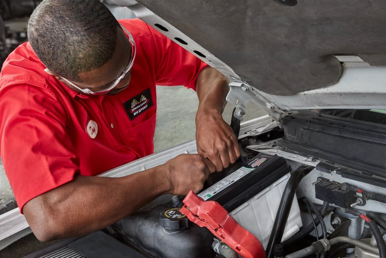 A Big O Tires employee is working on a car