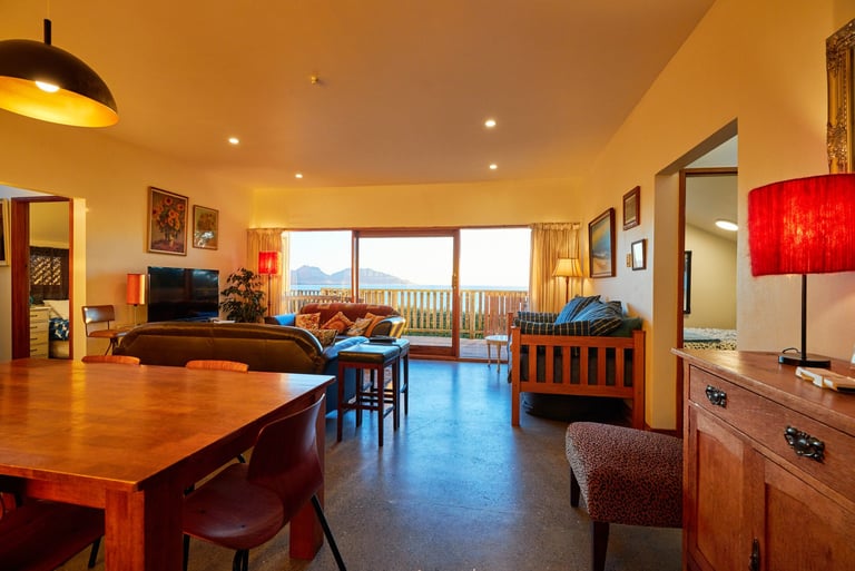 Open-plan kitchen, dining and lounge area at The Cottage Kaikōura