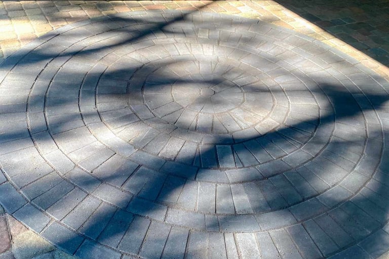 Stamped concrete vs. wood decking vs. natural stone patio comparison.