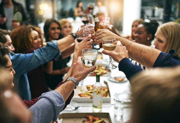 a group of people toasting with glasses of wine