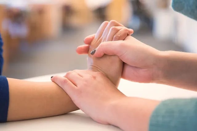 therapist stretching a patient's wrist