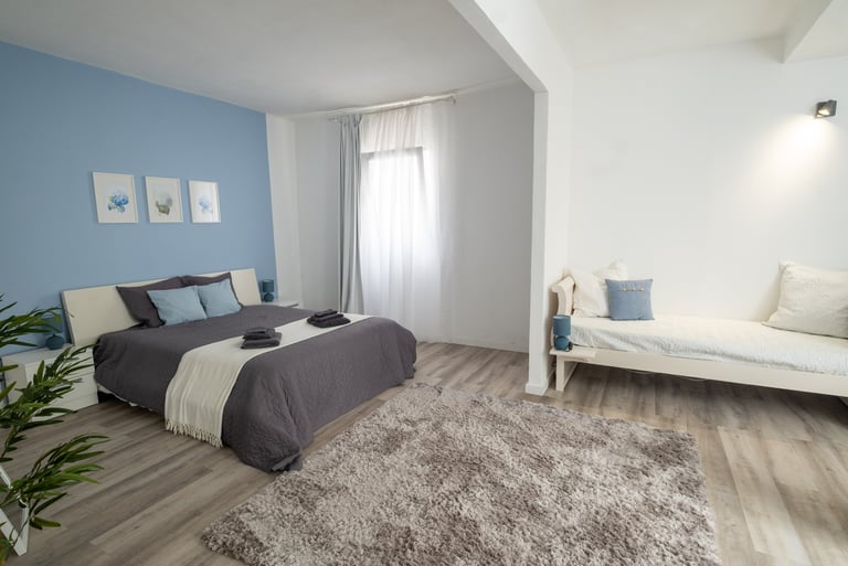 a bedroom with a bed and a couch