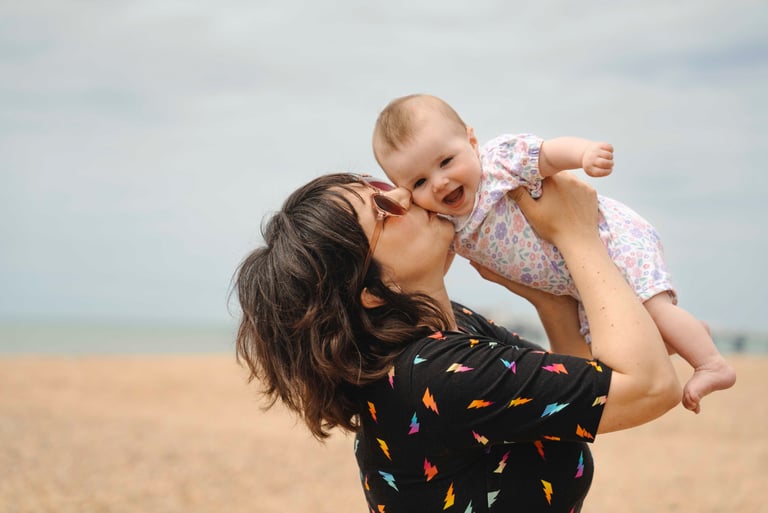 mother kissing her baby 
