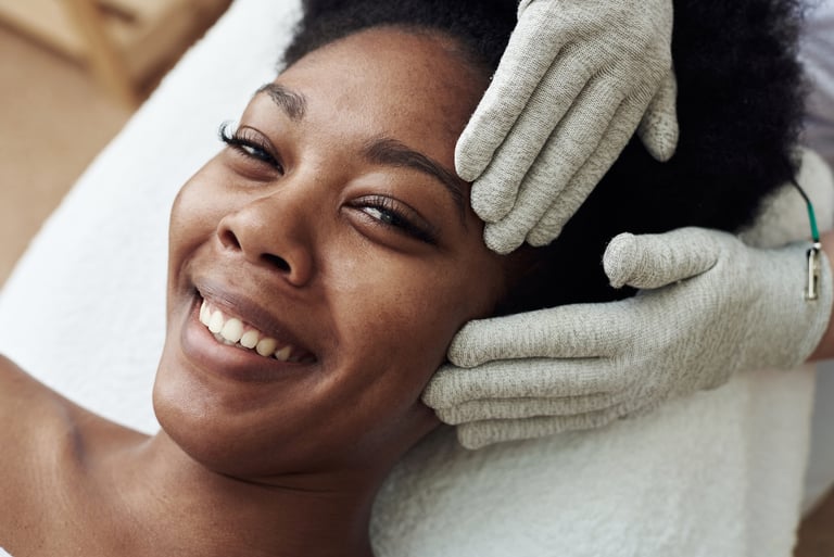 Woman smiling as she receives skin care services