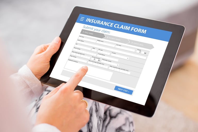 a person holding a tablet with a tablet screen displaying a claim form of insurance