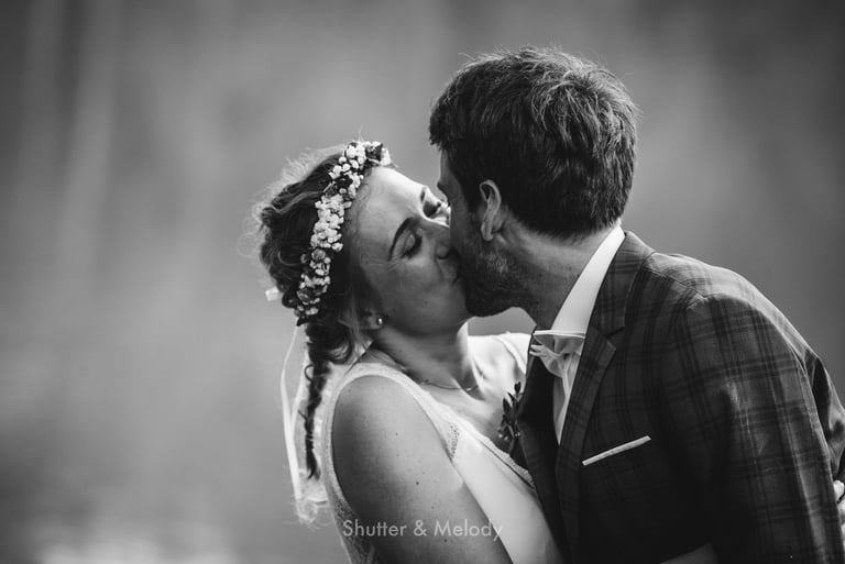 Bride and groom sharing a kiss.