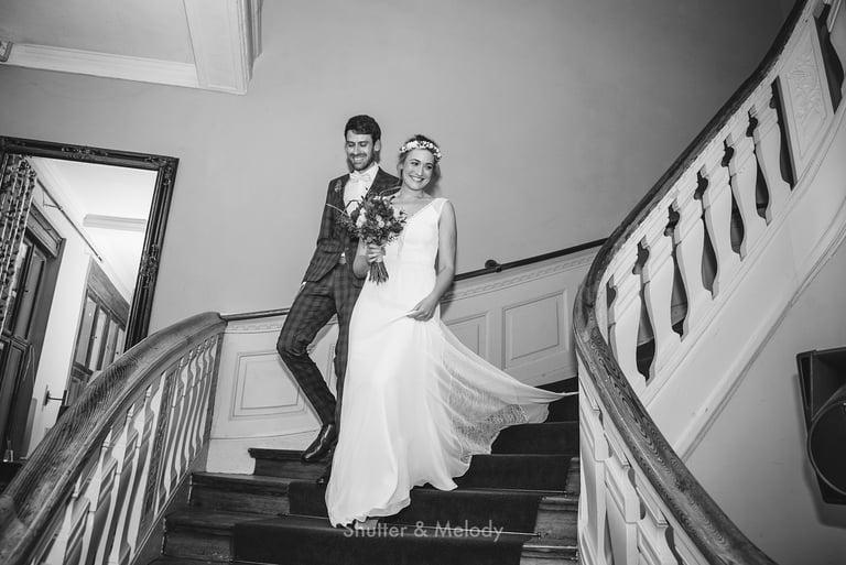 Bride and groom walking down the stairs for the ceremony.