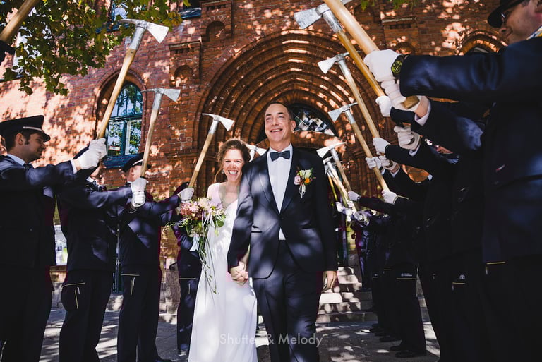Bride and groom send off with firemen.