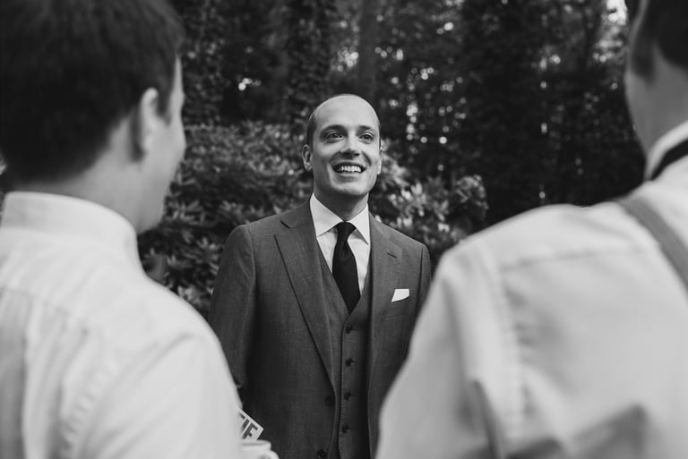 Groom talking to guests at reception.