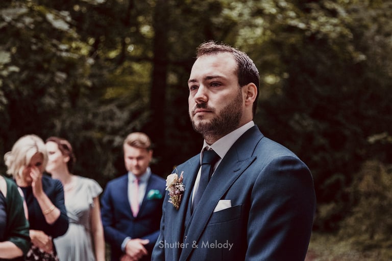 Groom crying at the altar.