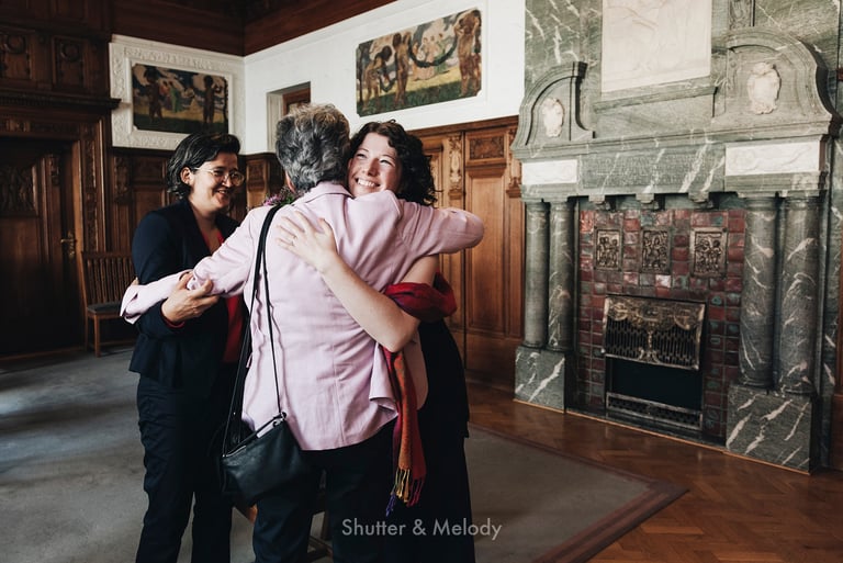 Bride is hugging her mother after civil wedding ceremony.