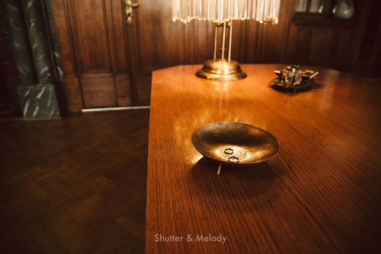 Wedding rings on a metal plate on a table.