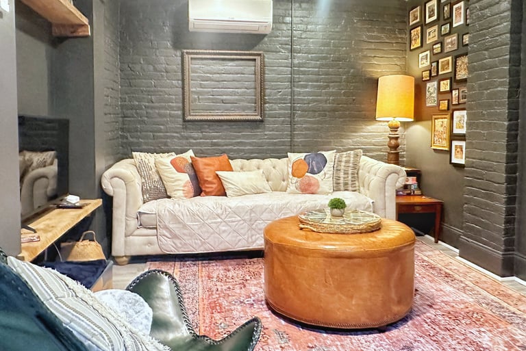 Guest nest apartment 2123 rivermont living room with white couch and gray brick walls