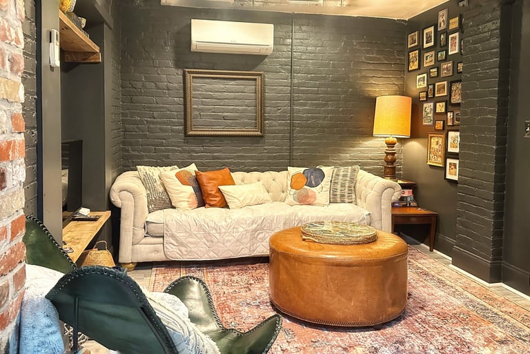 living room with white sofa and brick painted walls 