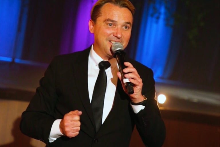 Professional fundraising emcee Craig Rosie capturing room energy during a California gala.