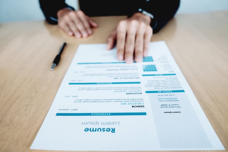 a person sitting at a table with a resume from ededge